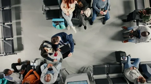 Sleeping, flight schedule screen and sisters in airport lounge next to people Video stock 333650900