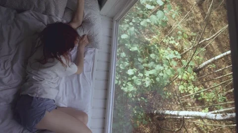 Sleeping girl in bed with forest view. Healthy sleep concept Stock Footage 288593380