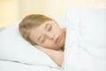 The sleeping girl lay on the bed Photo