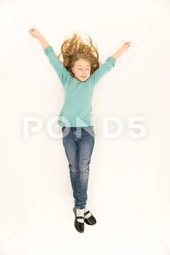 The sleeping girl lay on the floor. View from above Stock Photos