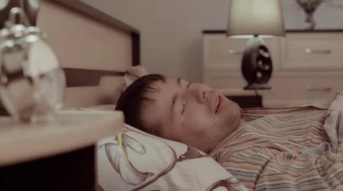 Sleeping handsome young man having a nightmare Видео 68421429