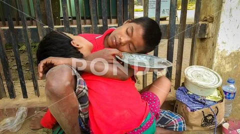 Sleeping hunger two sibling inside of the road when they are extremely hungry Stock Photos