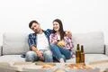 The sleeping man and a woman sit on the sofa on the white wall background Photo