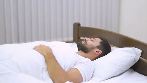 The sleeping man lay on the bed. Real time capture Video stock 71963504