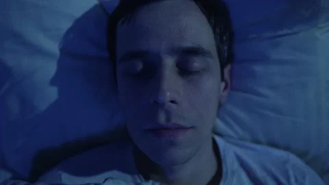 Sleeping man quickly opens his eyes Stock-Footage 165826135