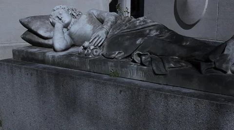 The sleeping man statue on the tomb in Pere Lachaise in Paris Stock Footage 64195822