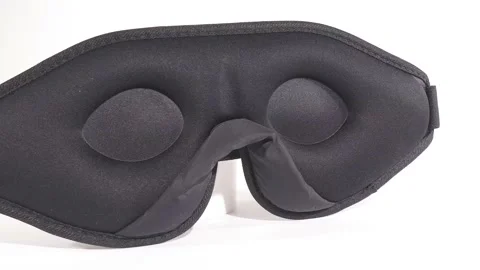 Sleeping mask made of black polyester on the inside Stock Footage 158882521