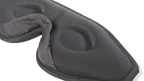 Sleeping mask made of black polyester on the inside Stock Footage 158882535