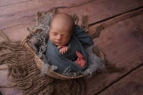 Sleeping newborn boy in the first days of life. Newborn photo session. Stock Photos