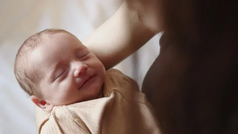 Sleeping Newborn Held by Mother Stock Footage 311829832