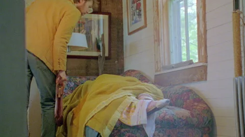 Sleeping person on Sofa being checked on 1970s Stock Footage 272311152