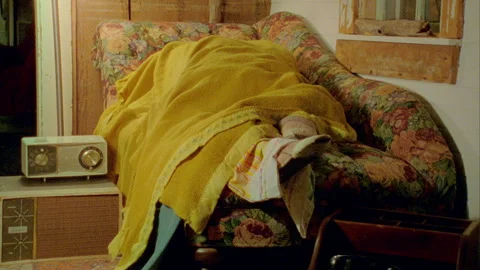 Sleeping Person under blanket on the couch 1970s 1960s Stock Footage 272386060