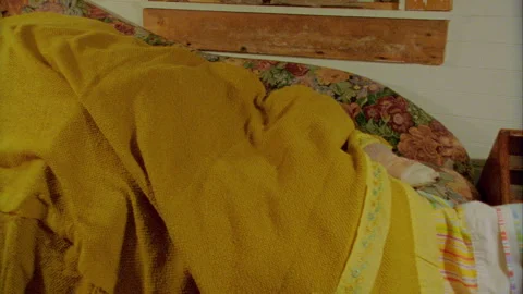 Sleeping Person under blanket on the couch 1970s Stock Footage 272387345