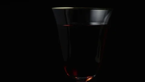 Sleeping pills fall into a glass of wine slow mo Stock Footage 73131845