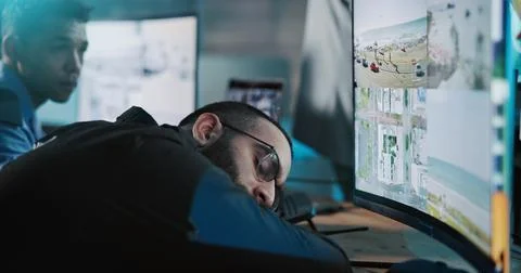Sleeping, security guard and computer for surveillance, camera and cctv mon.. Stock Photos