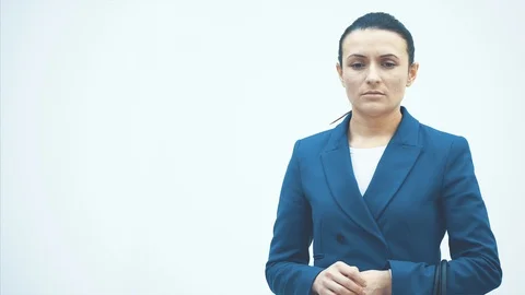 Sleeping teacher stands on a white background. Holds a white round clock. Drink Vidéo 117377550