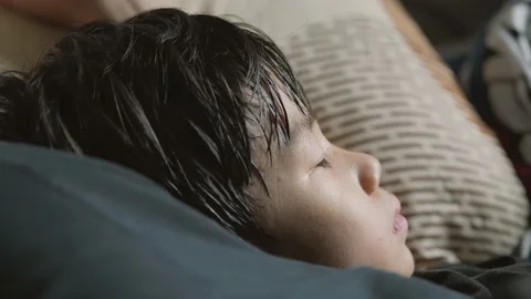 Sleeping tired Asian boy with excessive sweating. Video stock 196663511