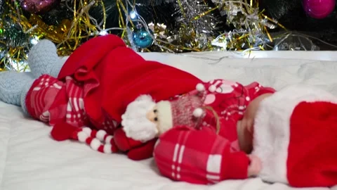 Sleeping, two week old, newborn, baby boy wearing a crocheted Santa hat wit.. Stock Footage 293730507