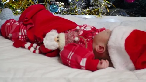 Sleeping, two week old, newborn, baby boy wearing a crocheted Santa hat wit.. Stock Footage 293730618