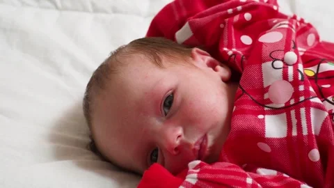 Sleeping, two week old, newborn, baby boy wearing a crocheted Santa hat wit.. Stock Footage 293731570