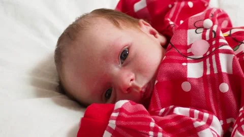 Sleeping, two week old, newborn, baby boy wearing a crocheted Santa hat wit.. Stock Footage 293731750