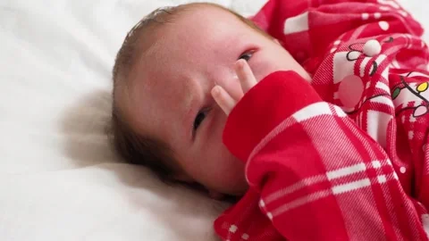 Sleeping, two week old, newborn, baby boy wearing a crocheted Santa hat wit.. Stock Footage 293731872