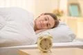 The sleeping woman on the background of a clock Photo