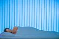The sleeping woman lay on the bed. Evening night time Photo