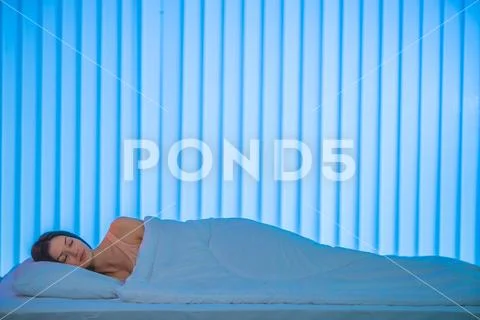 The sleeping woman lay on the bed. Evening night time Stock Photos
