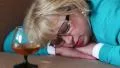 Sleeping woman lying on sofa with a glass of cognac HD Footage