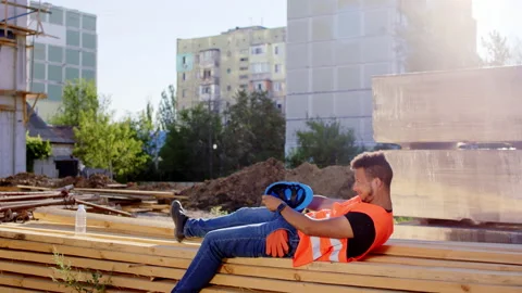 Sleeping at work tired construction worker Afro American he wake up take his Video stock 146603977