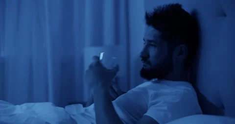 Sleepless man lying on bed and taking pill with water Stock Footage 271159916