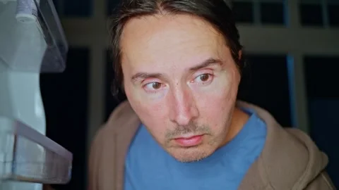 A sleepy and tired man opens an empty refrigerator at night and takes out an Stock Footage 309245111