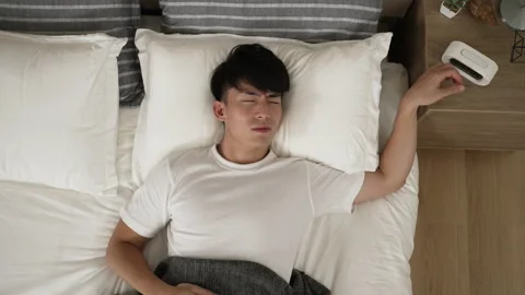 Sleepy asian man unable to wake up Stock Footage 211665201
