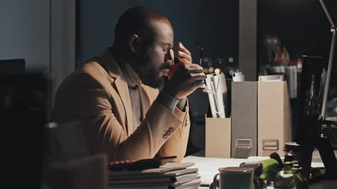 Sleepy Black Businessman Working on Computer at Night Stock Footage 233587735
