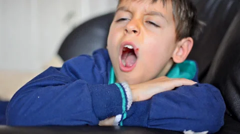 sleepy boy on sofa shows shh hush expres... | Stock Video | Pond5, image size:480x268