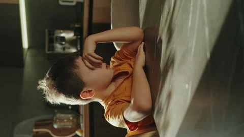 Sleepy boy standing at the kitchen table waiting for food. Stock Footage 257543611