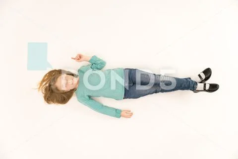 The sleepy girl lay on floor. View from above Stock Photos