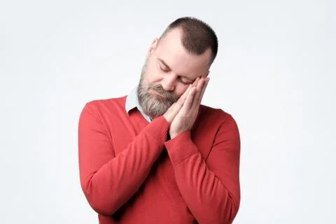 Sleepy guy having time break at work, dozing on his hands. Stock Photos