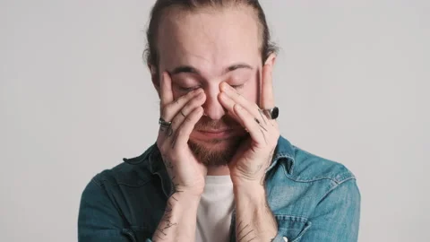 Sleepy guy rubbing face trying to wake up Stock Footage 150343367
