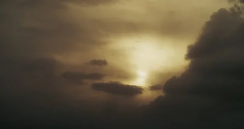 Sleepy, late-day clouds and sun diffused by the arrival of dusk. Video stock 264198002