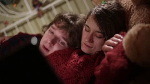 Sleepy Lovers Snuggled in Bed Watching Videos on Laptop Stock Footage 72199872