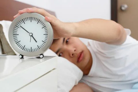 Sleepy man with clock Stock Photos