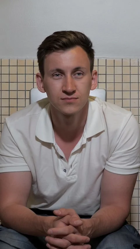 Sleepy man falling asleep sitting on a toilet Stock Footage 341446744