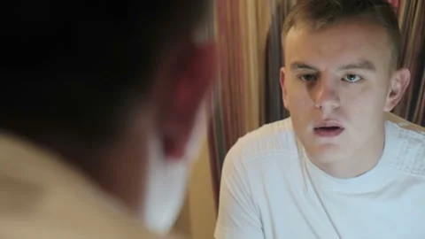 Sleepy man looking at himself in the mirror Stock Footage 122696644