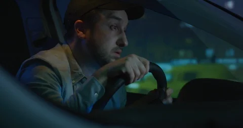 Sleepy man slapping himself while driving Stock Footage 125471845