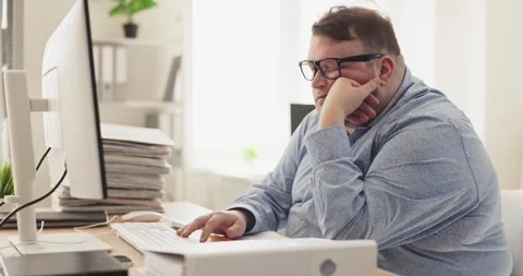 Sleepy office accountant with fatigue at computer amid paperwork and deadlines Stock Footage 336850352