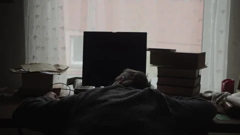 Sleepy Programmer Slumped Over Keyboard in Dark Home Office early morning Stock Footage 336718910