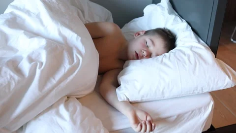 Sleepy toddler boy lying in bed and crying. Tired child in bedroom. Stock Footage 172011036