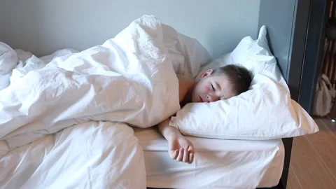 Sleepy toddler boy lying in bed and crying. Tired child in bedroom. Stock Footage 172011213